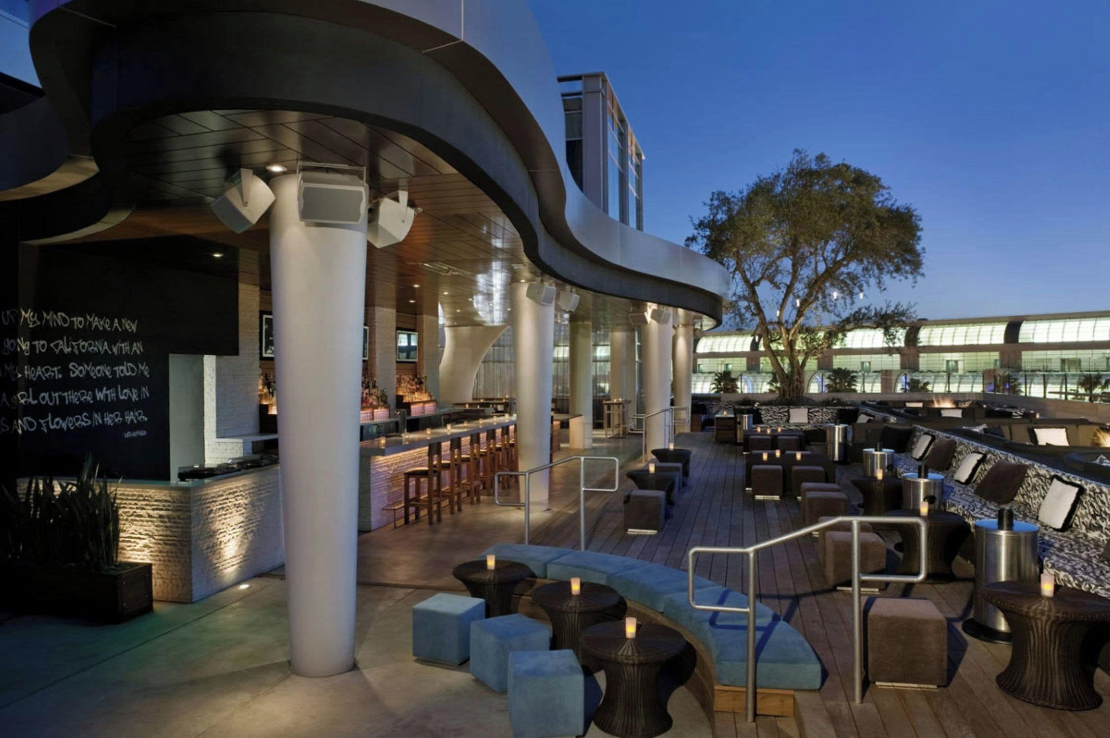 An outdoor seating area with modern furniture and a bar.
