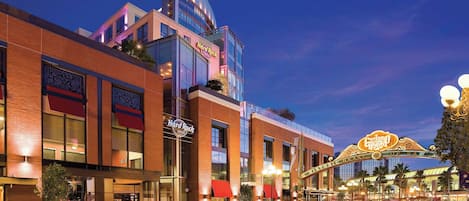 A hotel with a prominent sign, a street with light trails, and a casino entrance.