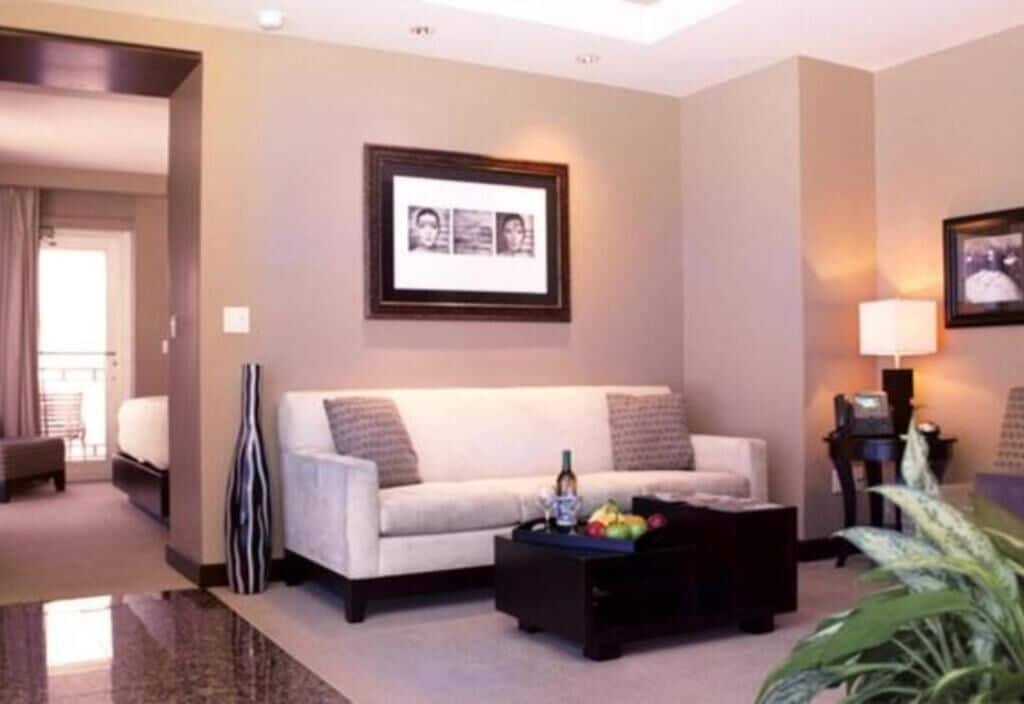 Ein modernes Wohnzimmer mit einer Couch, einem Couchtisch und gerahmten Bildern an der Wand.