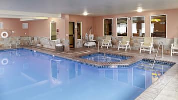 Relax by the pool surrounded by comfortable lounge chairs and a lifeguard stand for added safety.
