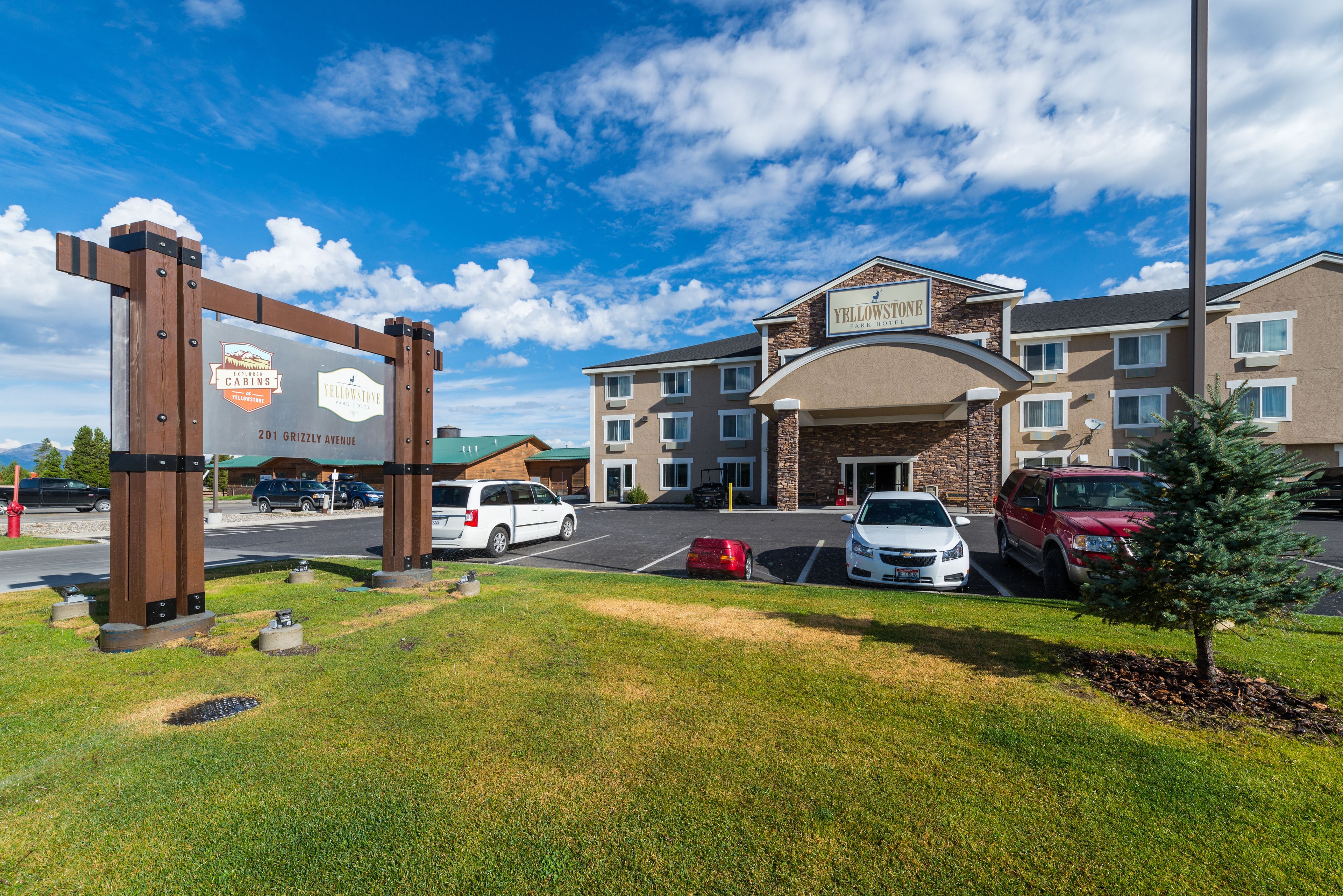A hotel entrance with a signboard indicating 'Yellowstone' and 'Cabins'.