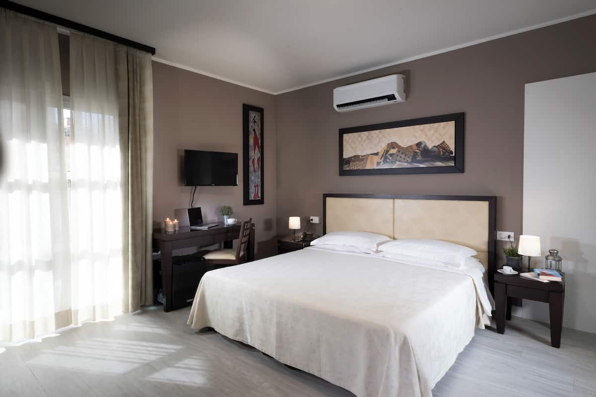 Hypo-allergenic bedding, desk, laptop workspace, blackout drapes