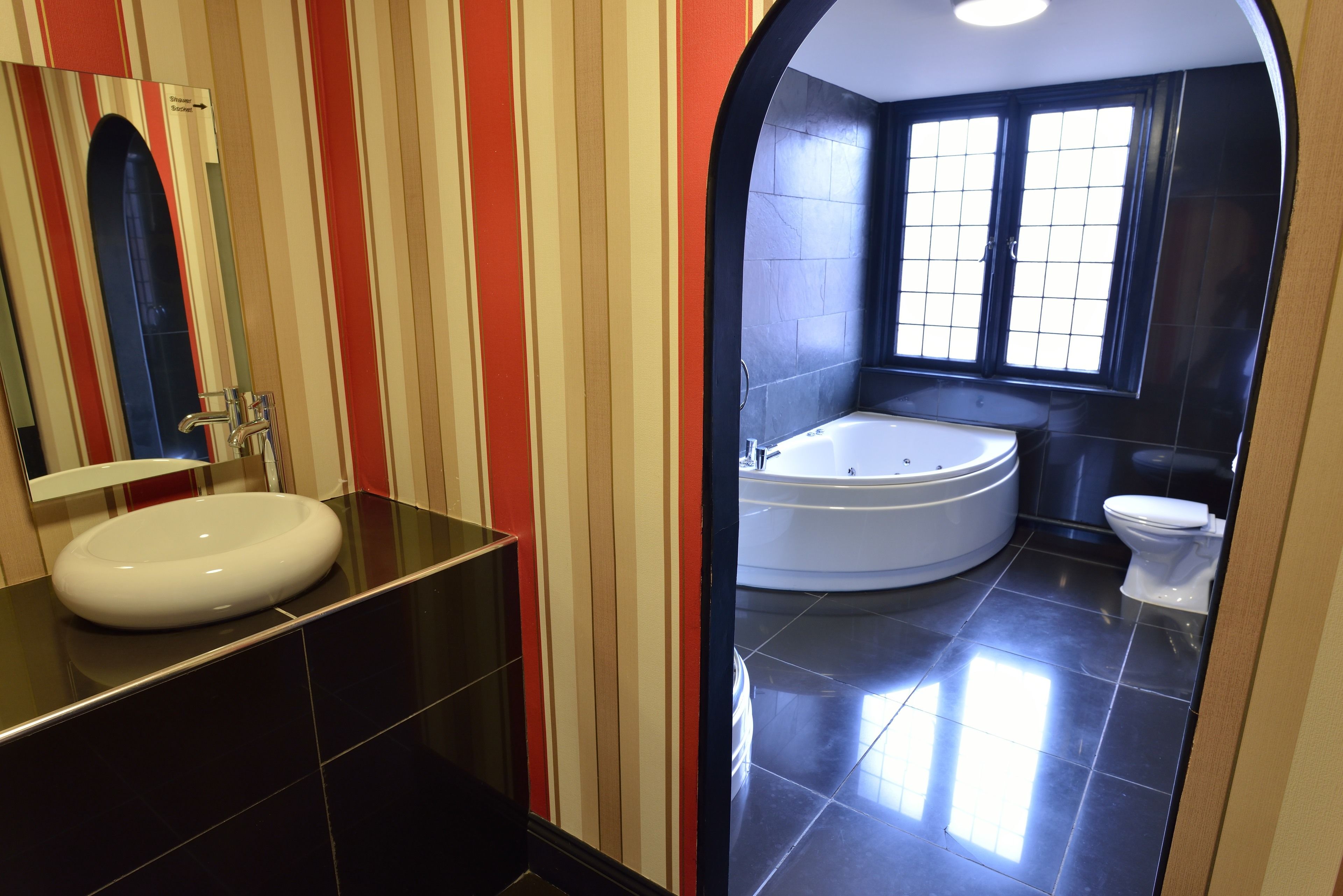 A bathroom with a white sink, a bathtub, and a toilet.