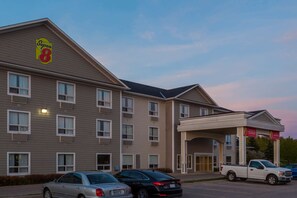 A Super 8 hotel with a two-story structure, multiple windows, and a covered entrance. - Super 8 by Wyndham Midland (Midland)