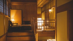 A traditional Japanese interior with wooden flooring, tatami mats, and sliding doors. - Tocen Goshoboh (Kobe)