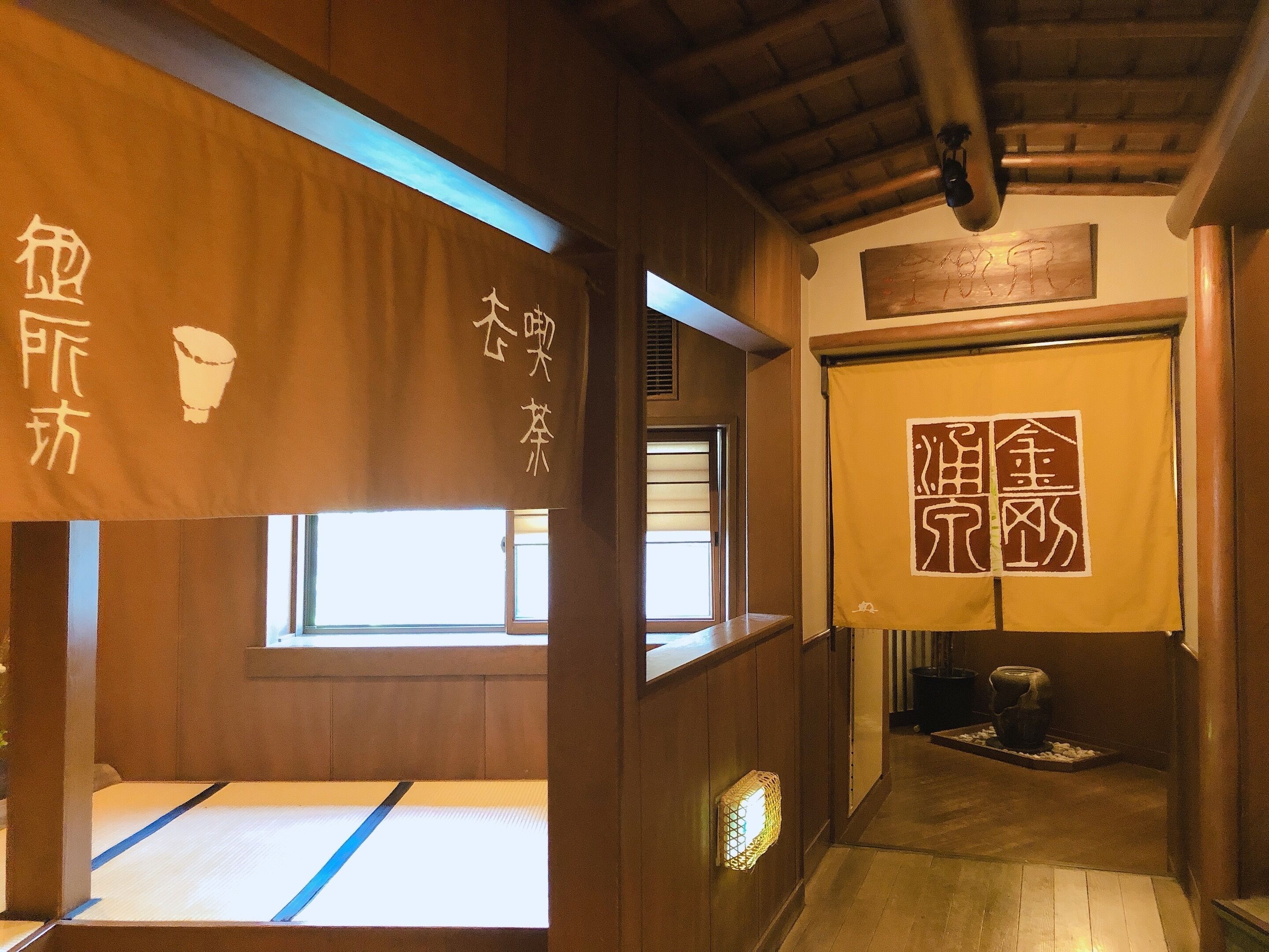 A traditional Japanese room with tatami flooring, wooden sliding doors, and a shoji screen.