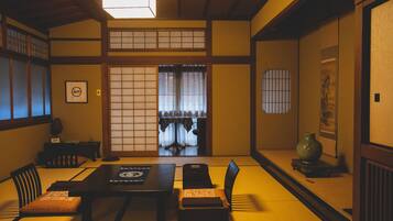 A traditional Japanese room with tatami flooring, a low table, and shoji screens.