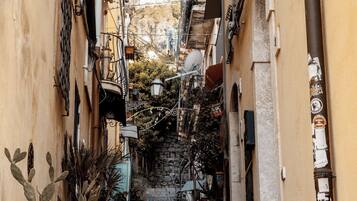 A narrow street with a staircase leading up to a building.