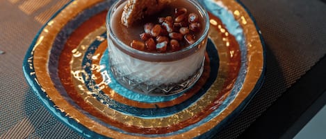 A dessert on a decorative plate with a textured mat underneath.