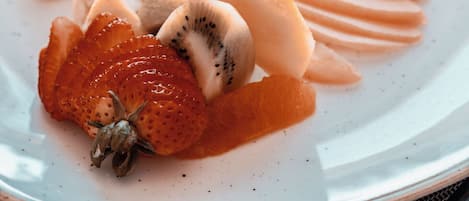 A plate of assorted fruits and a drizzle of sauce.