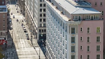 A multi-story building with a flat facade, large windows, and a parking lot in front.