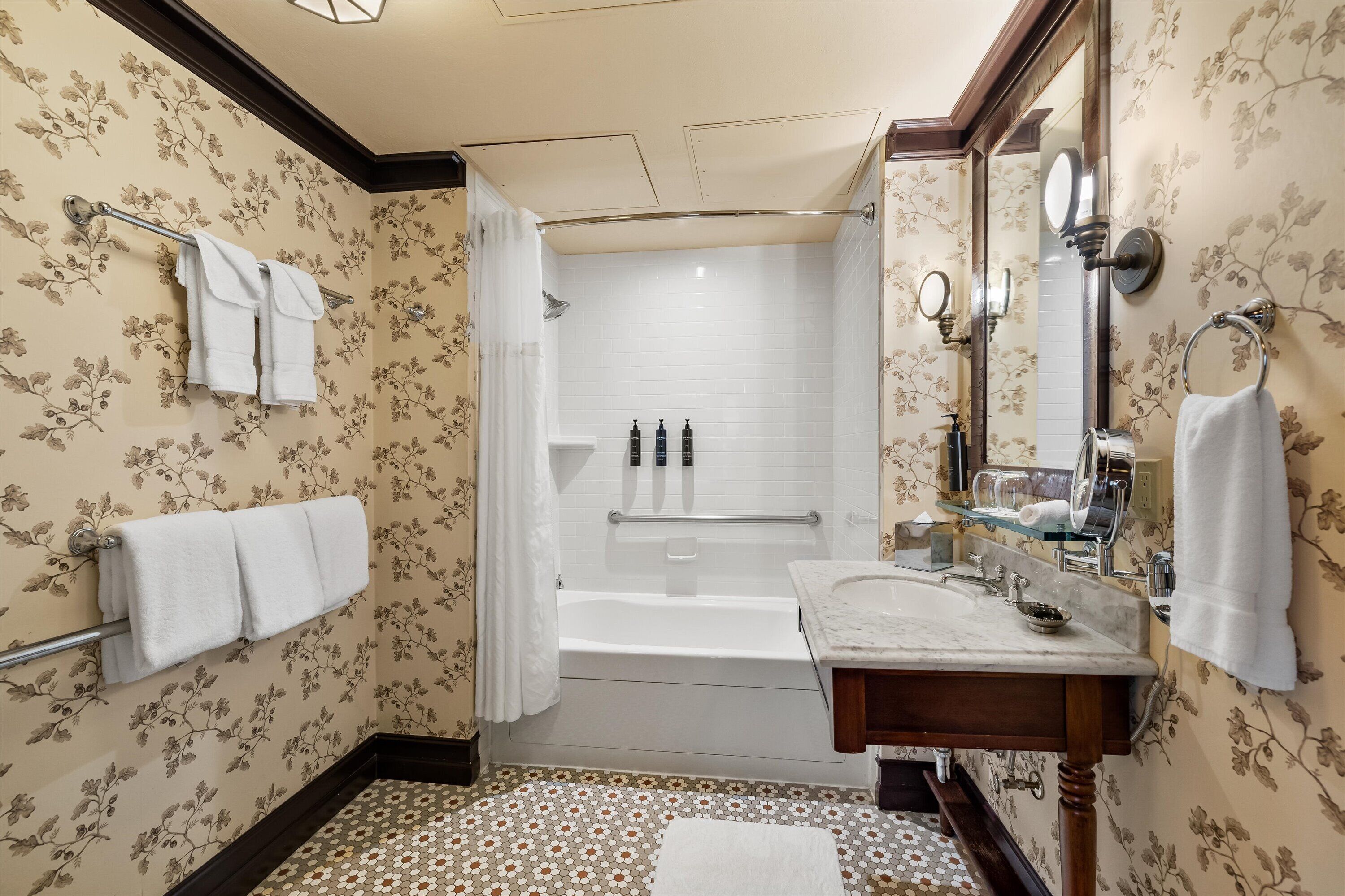 A bathroom with a bathtub, a sink, and a shower.