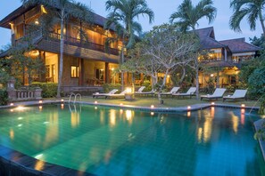 A large, two-story building with a swimming pool in front. - Ananda Cottages (Ubud)