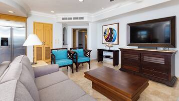 A modern living room with a sofa, a coffee table, a TV, and a painting on the wall.