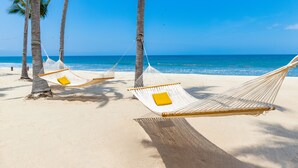 Two hammocks tied between palm trees on a sandy beach with the ocean in the background. - Villa La Estancia Beach Resort & Spa Riviera Nayarit (Nuevo Nayarit)