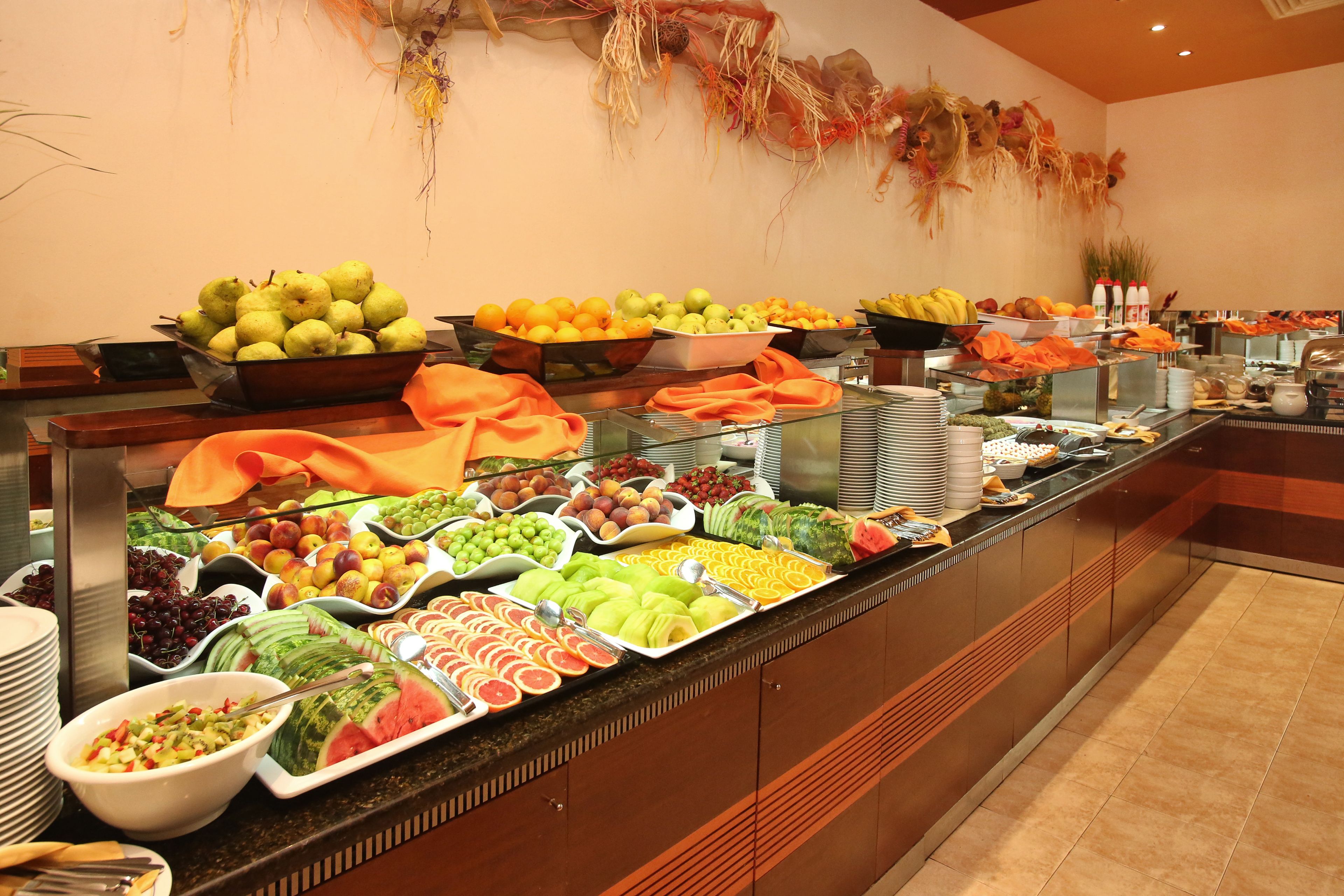 A buffet with various fruits and vegetables.