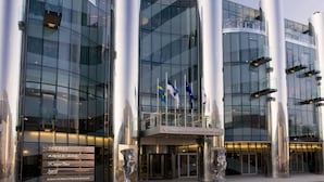 A modern building with reflective glass windows, large cylindrical columns, and a central entrance with a sculpture. - Tallink Spa and Conference Hotel (Tallinn)