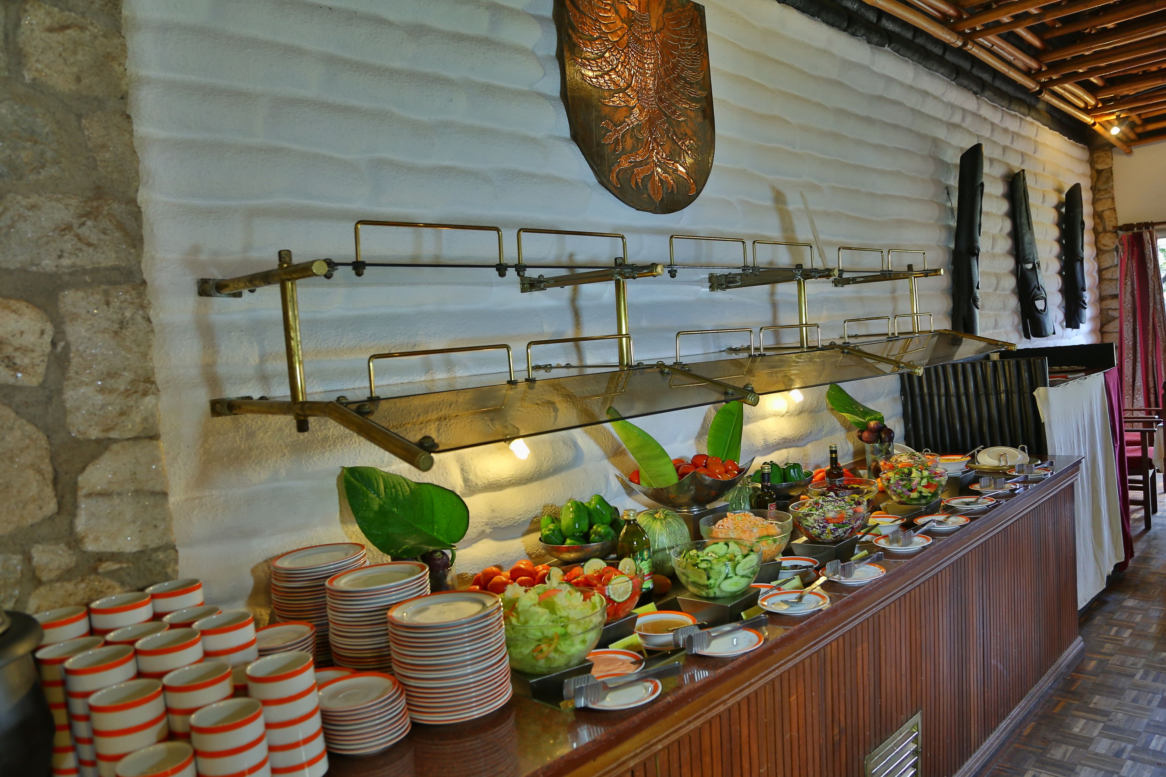 A buffet setup with various food items and utensils.