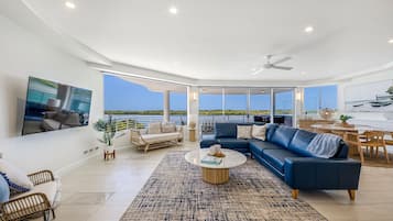 3 Bedroom Luxury Waterfront Apartment | Living area | 65-inch TV with cable channels, DVD player