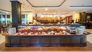 A buffet area with various food items and a large decorative structure resembling a camel. - Khemara Angkor Hotel & Spa (Siem Reap)