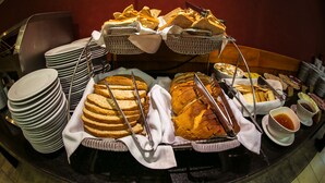 A buffet with various breads, pastries, and condiments. - Diego De Almagro Punta Arenas (Punta Arenas)