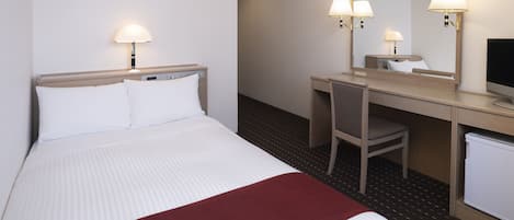 A hotel room with a bed, a desk, a chair, a television, and a mirror.