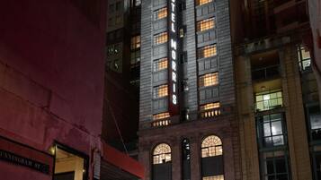A multi-story building with a prominent 'HOTEL MORRIS' sign, large arched windows, and a classic architectural style.