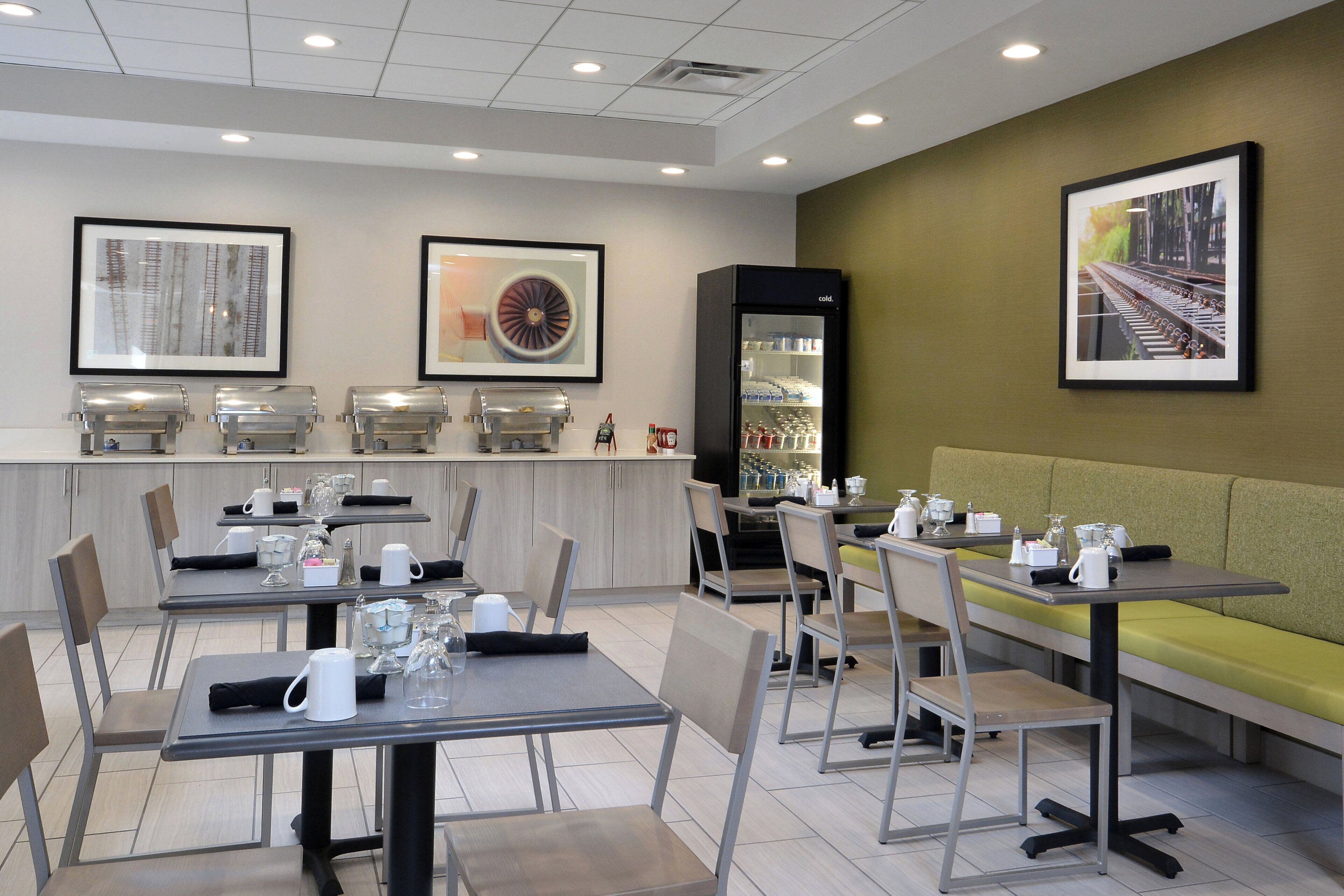 A modern dining area with tables, chairs, and a seating area.
