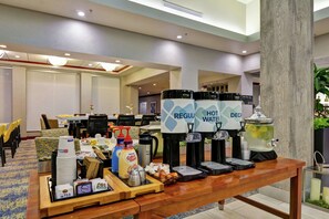 A hotel reception area with a buffet table, coffee and tea dispensers, and a water dispenser. - Hilton Garden Inn Conway (Conway)