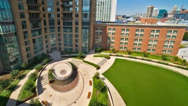 A modern building with a circular courtyard, surrounded by greenery and a central fountain. - Hilton Garden Inn Baltimore Inner Harbor (Baltimore)
