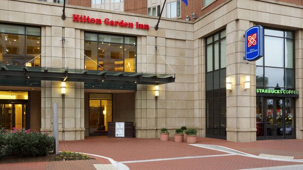 The exterior of Hilton Garden Inn with a Starbucks Coffee sign.