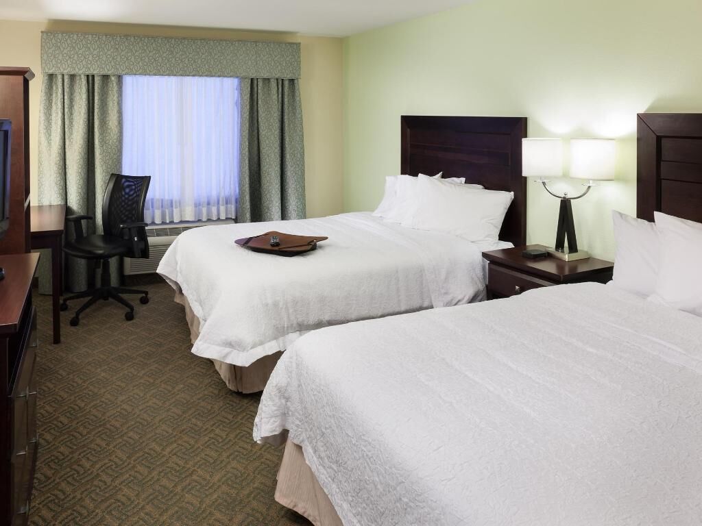 Premium bedding, desk, laptop workspace, blackout curtains