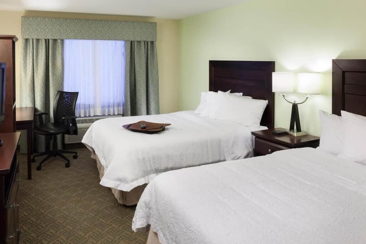 Premium bedding, desk, laptop workspace, blackout drapes