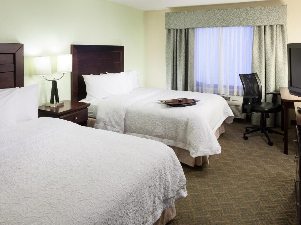 Premium bedding, desk, laptop workspace, blackout curtains