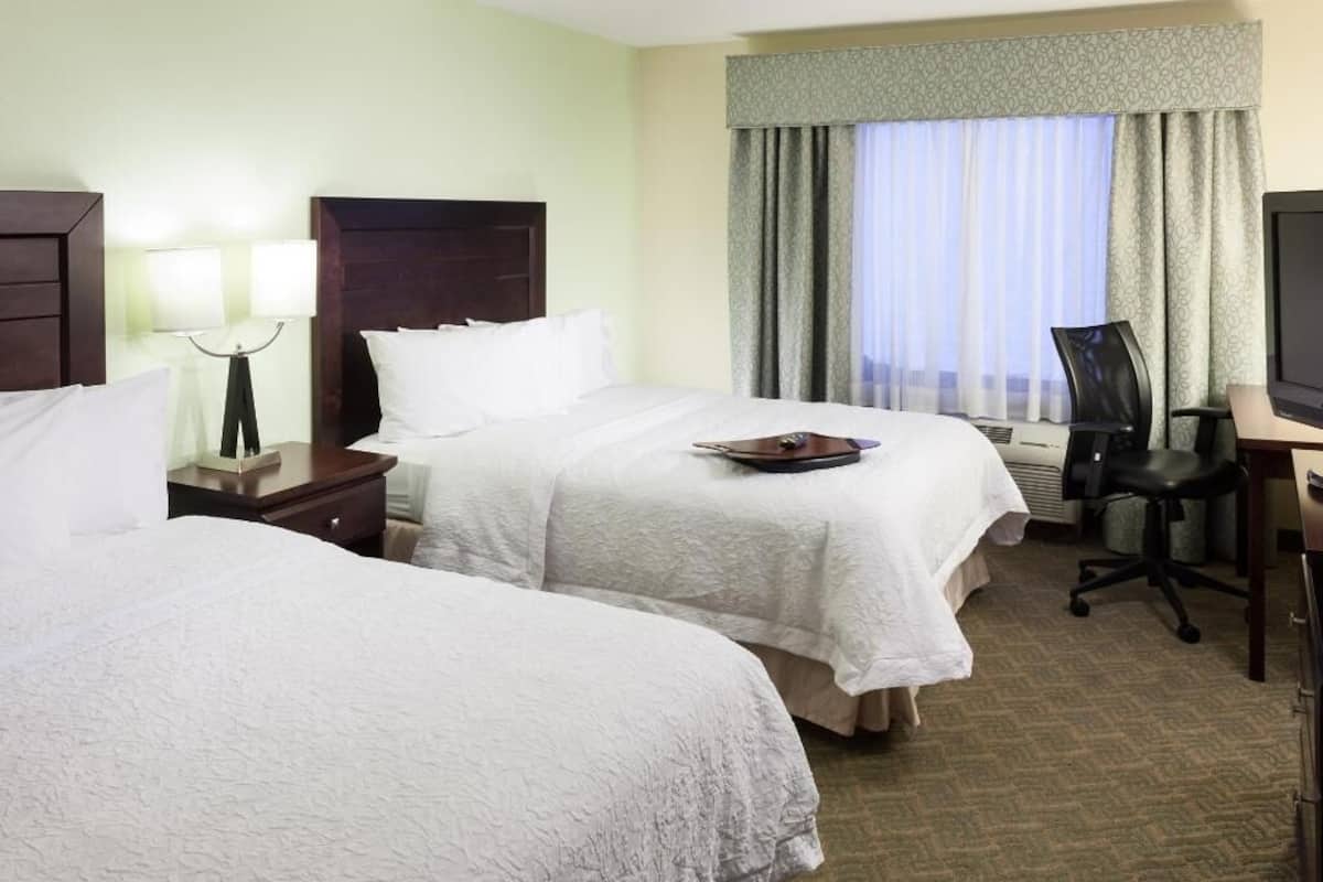 Premium bedding, desk, laptop workspace, blackout drapes