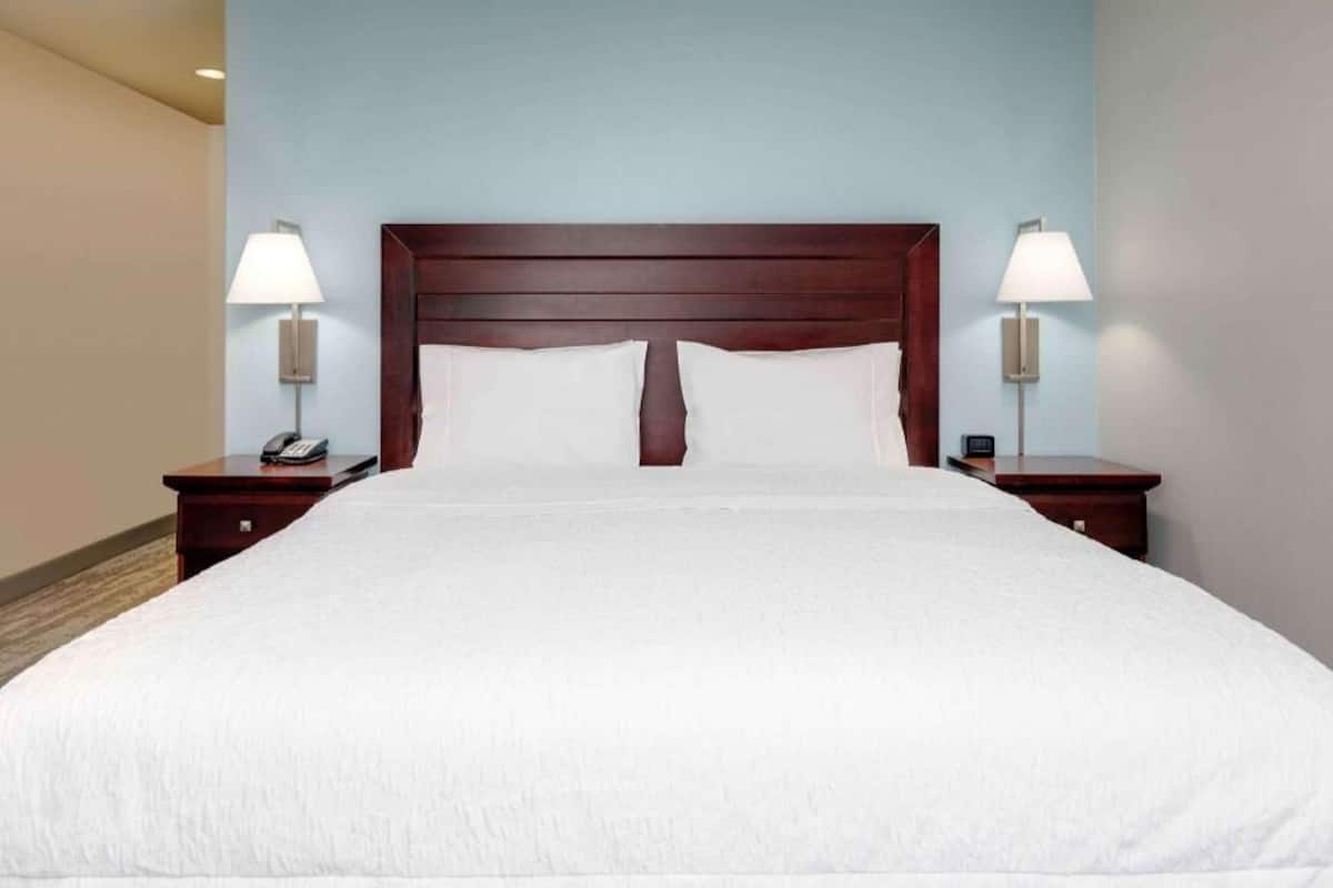 Premium bedding, desk, laptop workspace, blackout drapes