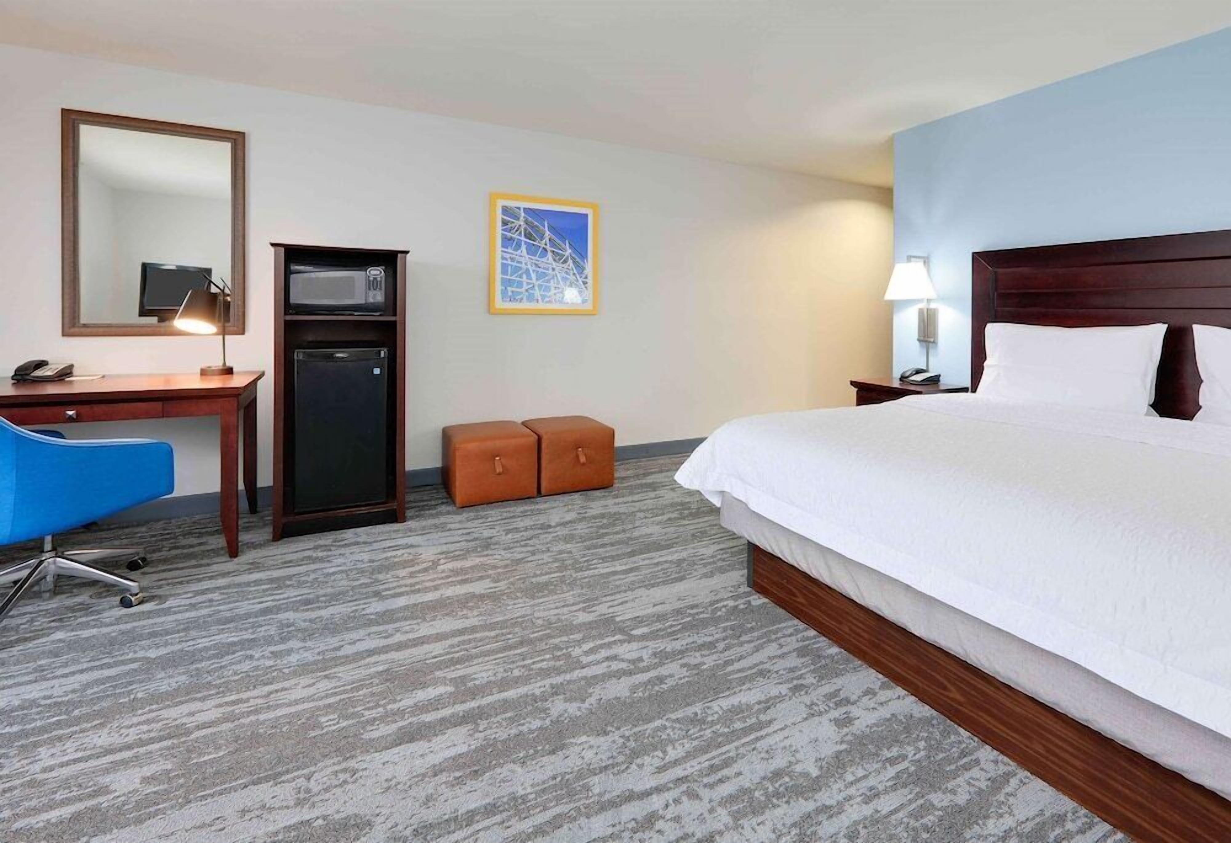 Premium bedding, desk, laptop workspace, blackout drapes