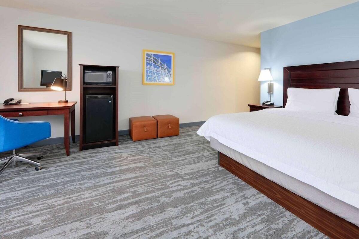 Premium bedding, desk, laptop workspace, blackout drapes