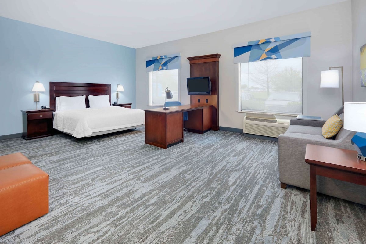 Premium bedding, desk, laptop workspace, blackout drapes