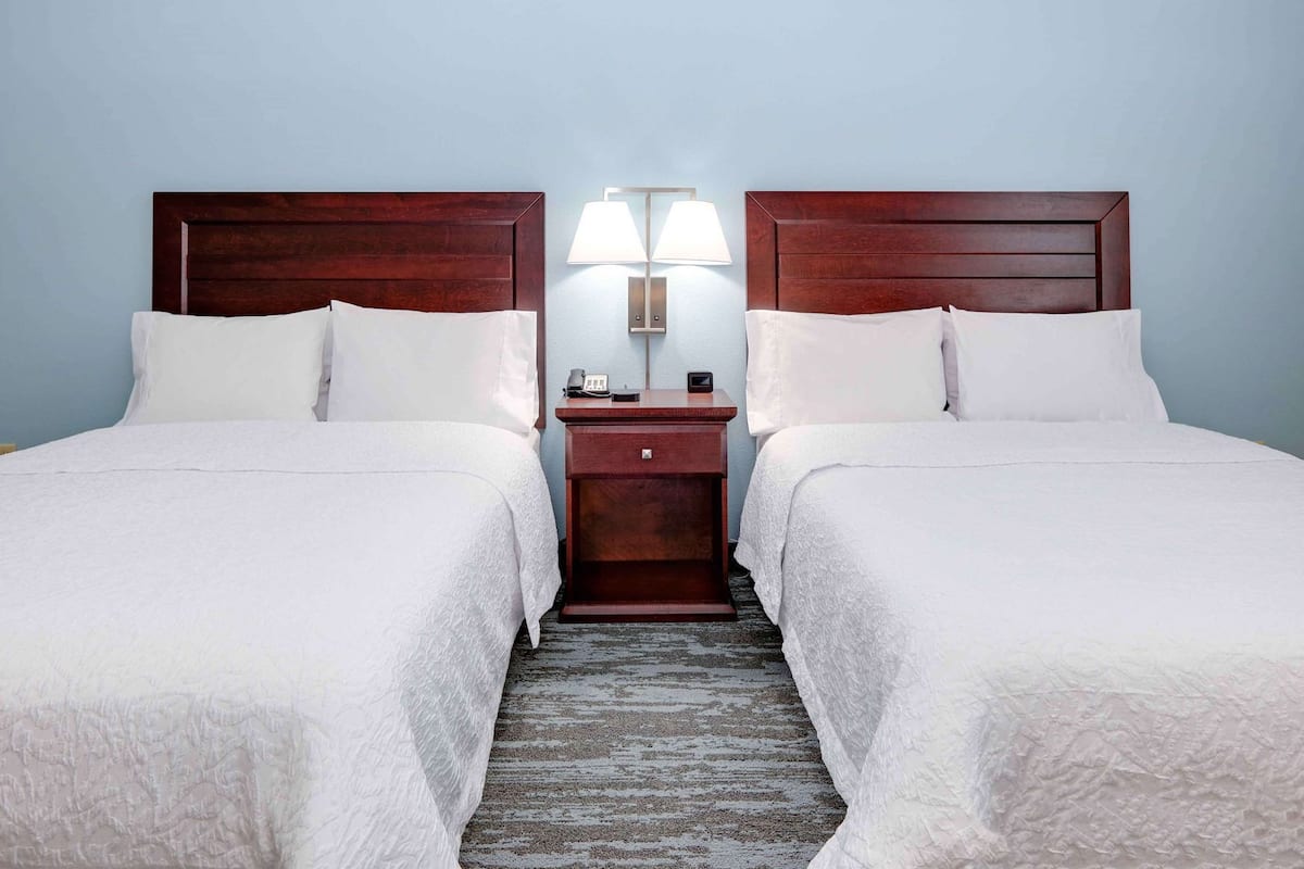 Premium bedding, desk, laptop workspace, blackout drapes