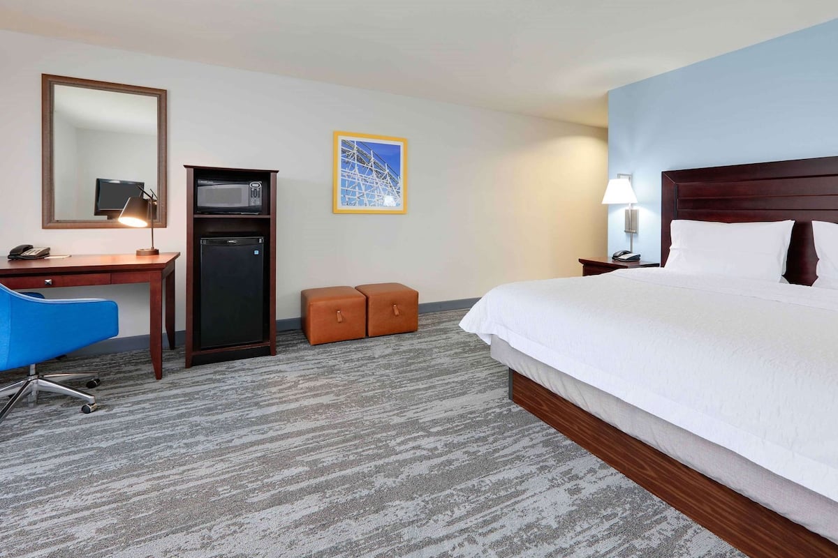 Premium bedding, desk, laptop workspace, blackout drapes