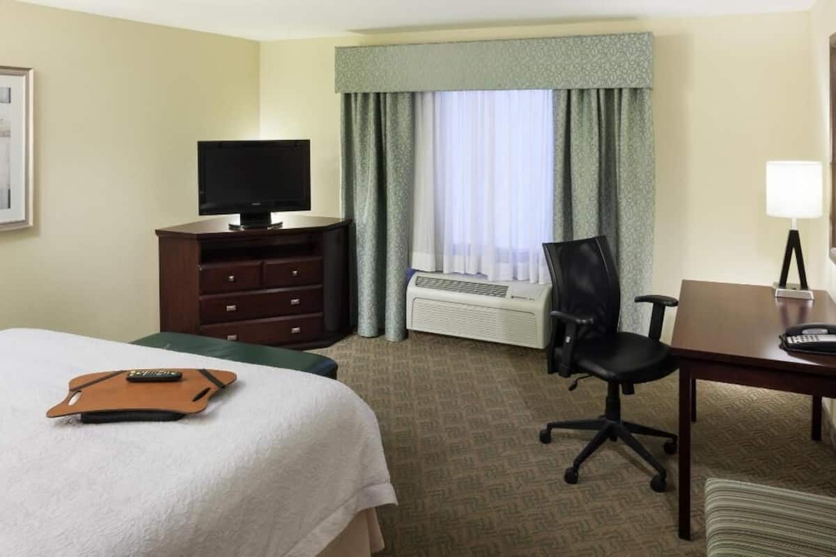 Premium bedding, desk, laptop workspace, blackout drapes