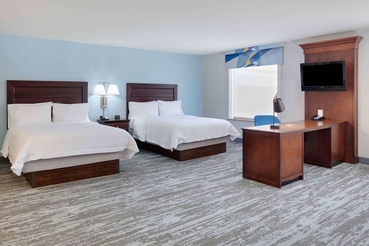 Premium bedding, desk, laptop workspace, blackout drapes