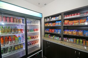 A vending machine stocked with beverages and snacks. - Holiday Inn Express Hotel & Suites Greensboro - East by IHG (Greensboro)