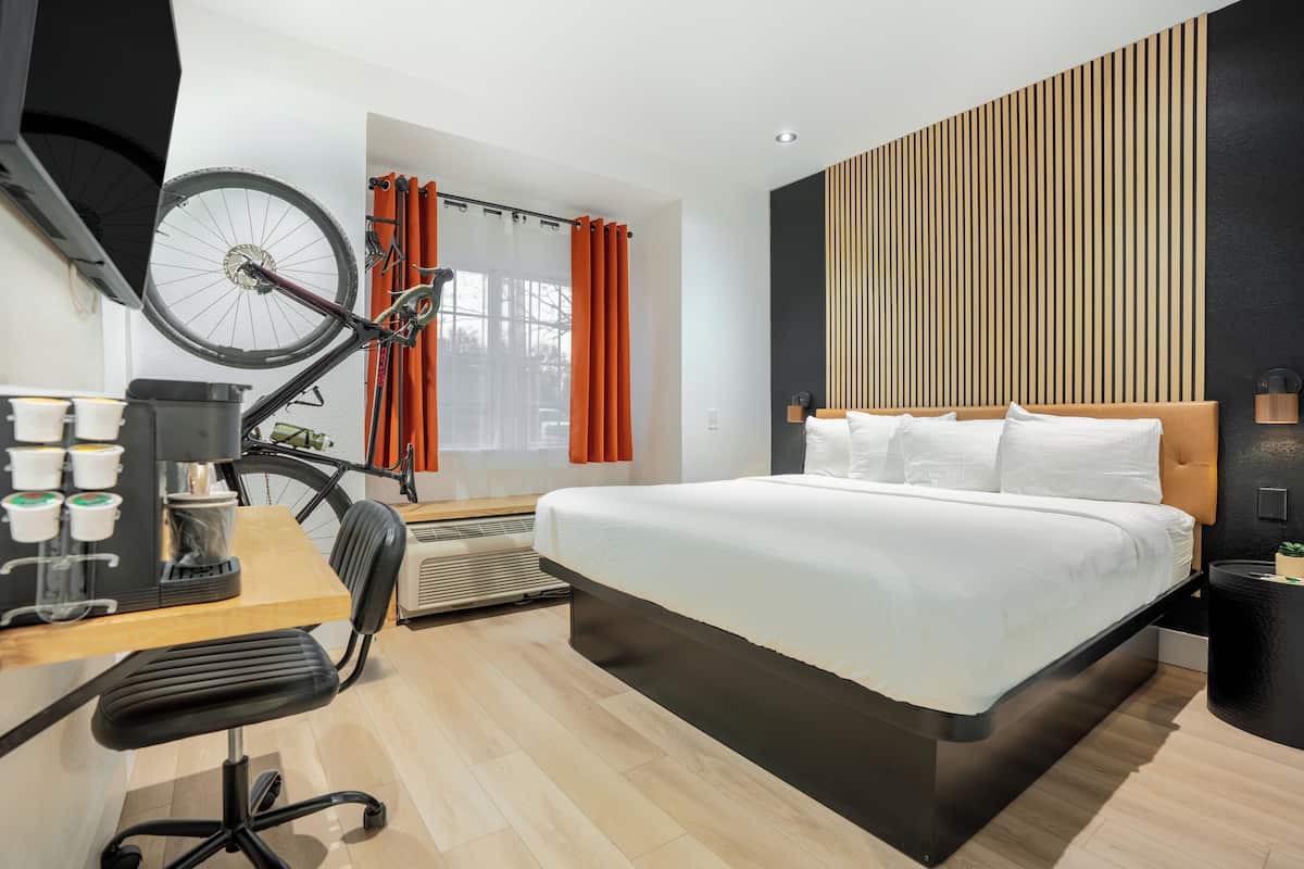 Premium bedding, desk, laptop workspace, blackout drapes
