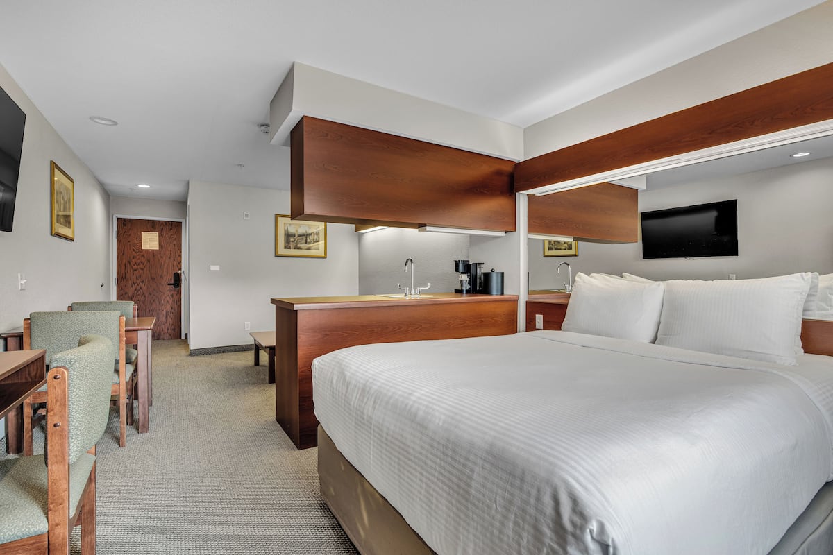 Premium bedding, desk, laptop workspace, blackout drapes