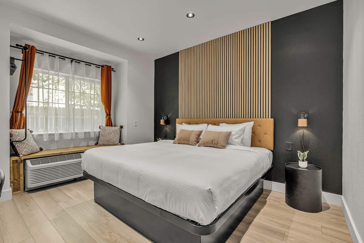 Premium bedding, desk, laptop workspace, blackout drapes