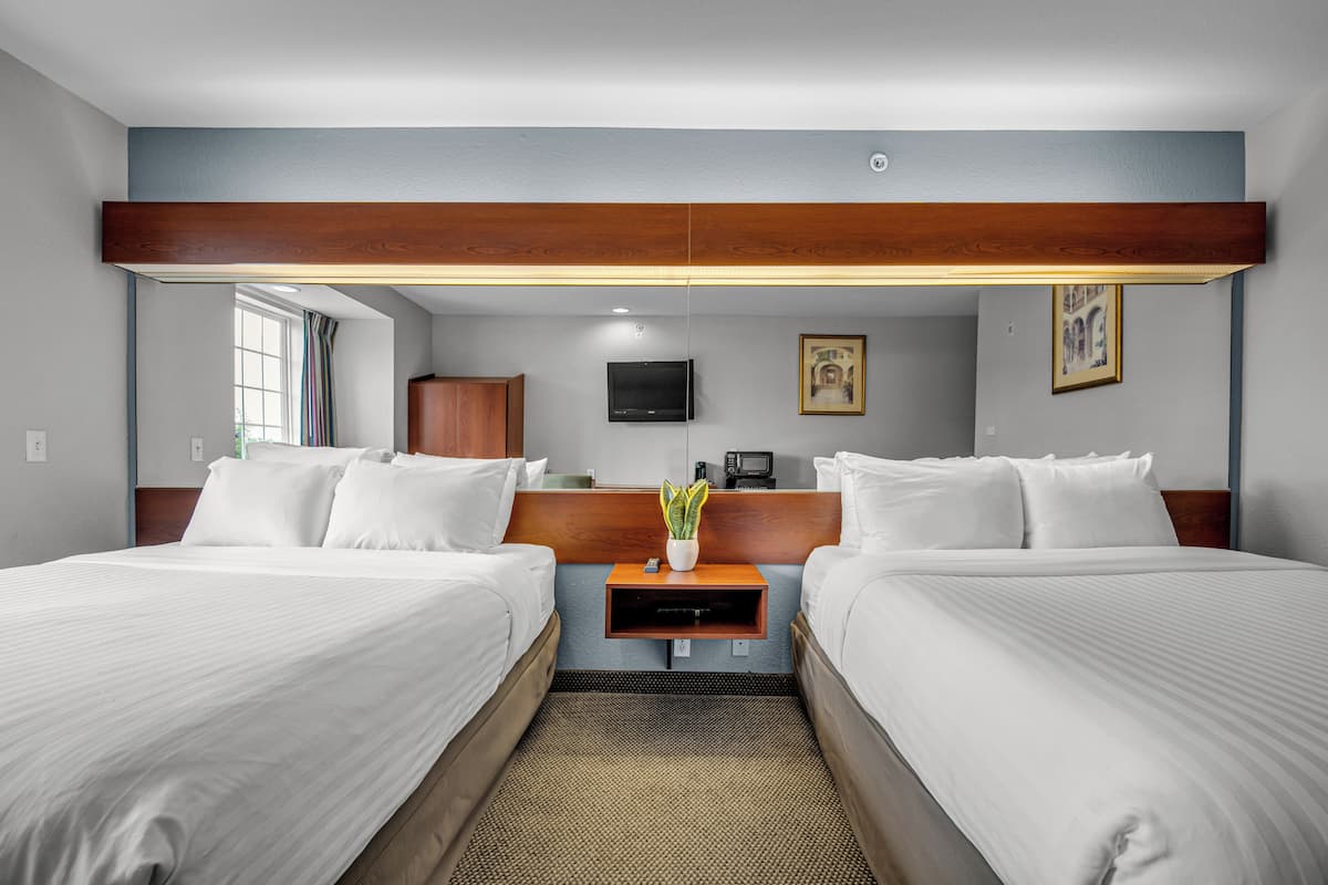 Premium bedding, desk, laptop workspace, blackout drapes
