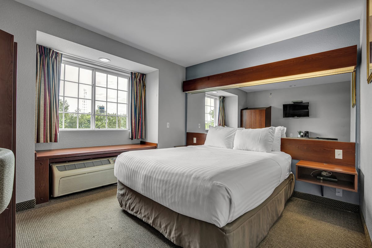 Premium bedding, desk, laptop workspace, blackout drapes