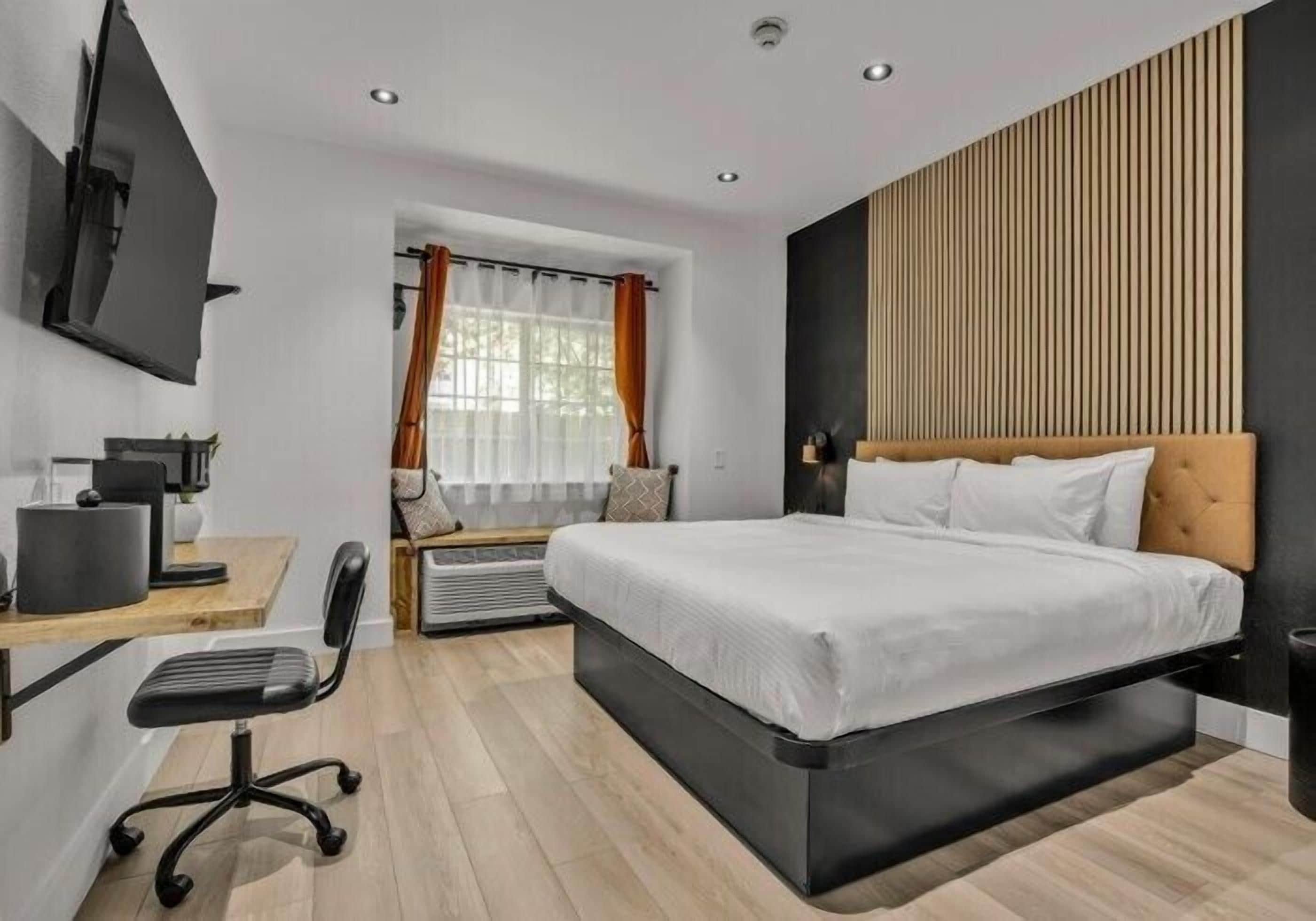 Premium bedding, desk, laptop workspace, blackout curtains